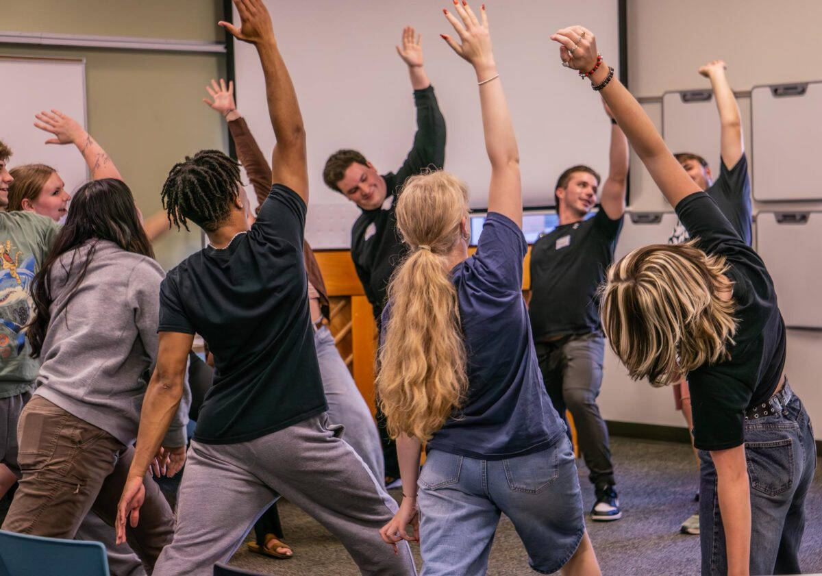 Students standing and stretching in unison